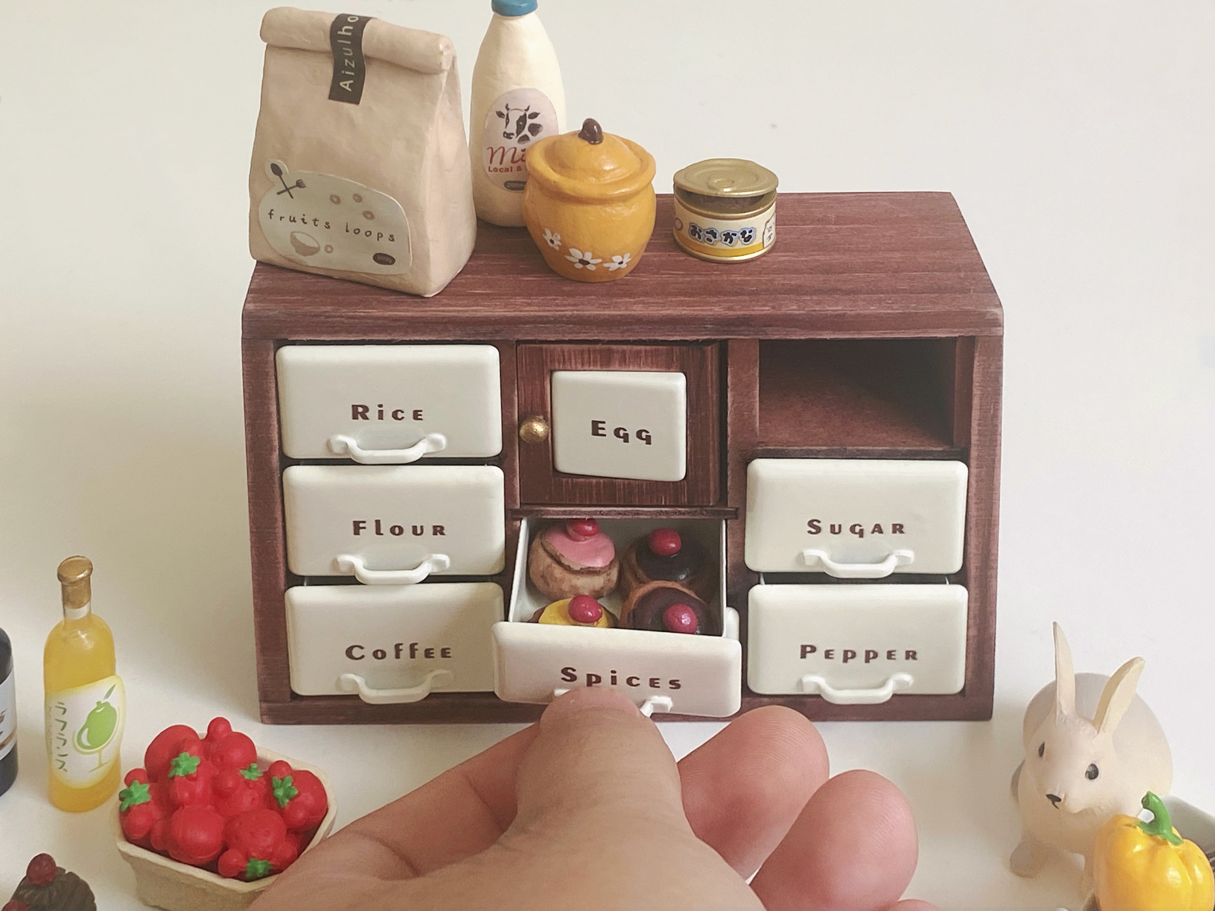 Red Bean spice cabinet with open Spices drawer filled with tiny desserts and pantry props
