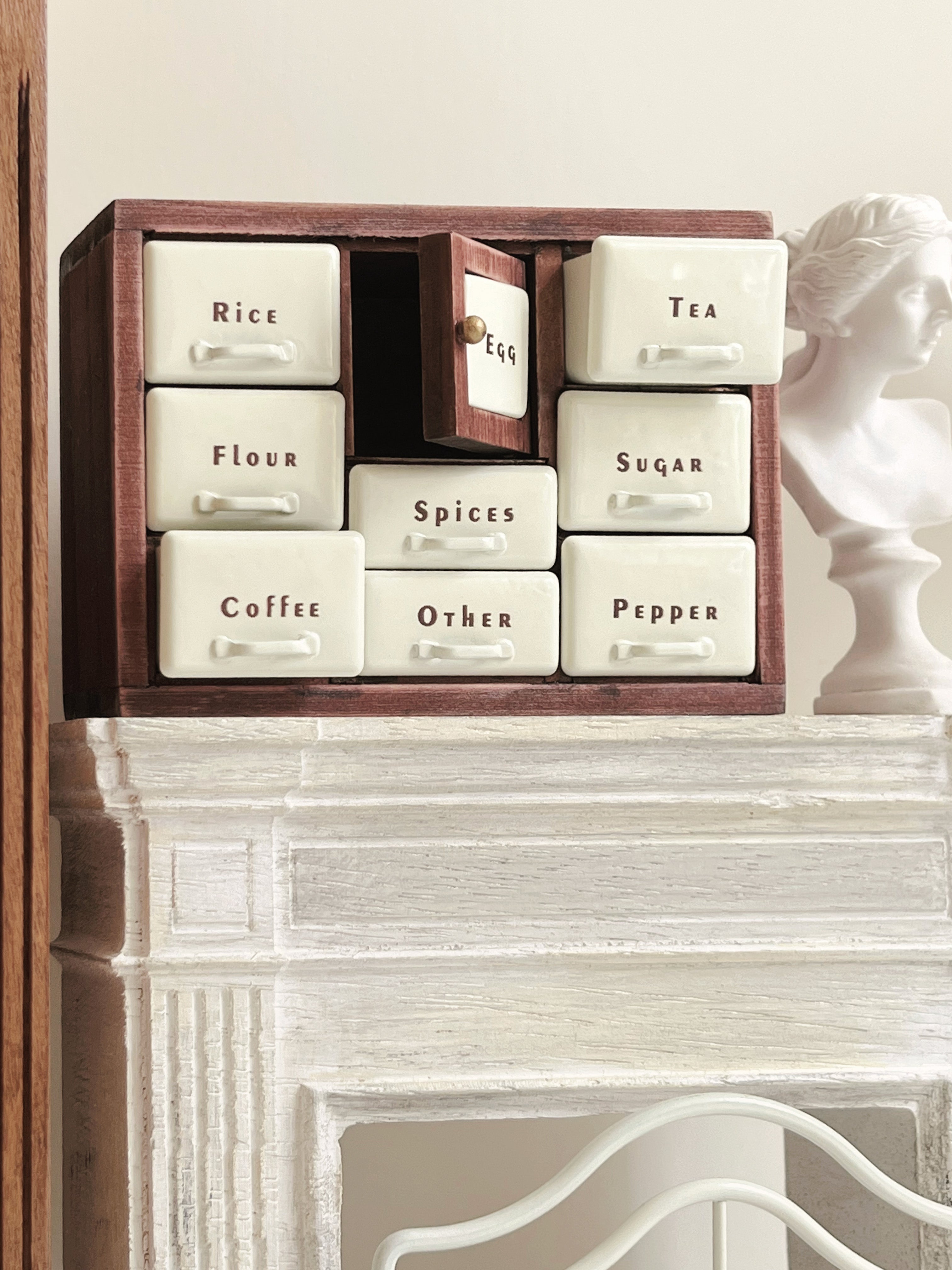 Red Bean miniature spice cabinet with center Egg door open and white bust display
